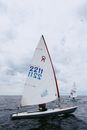 White Sail Boat on Sea Under White Clouds