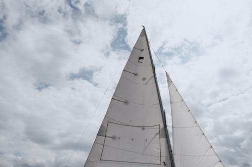 White Sail Boat Under Cloudy Sky