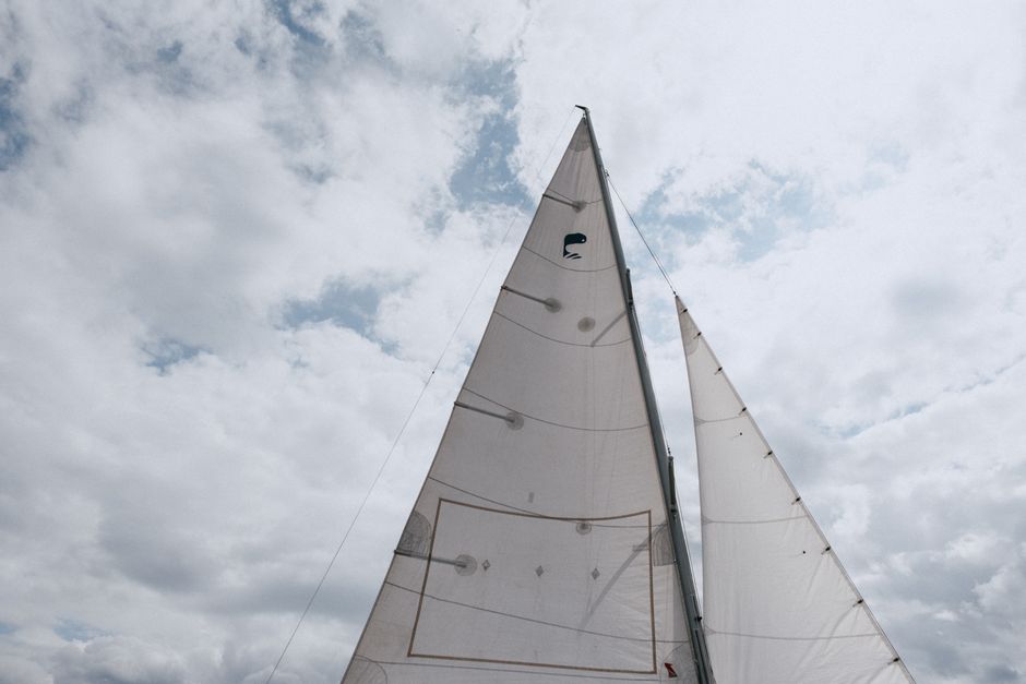 Ultimate Beautiful 90 Minute Catamaran Sunset Sail with Drinks! Review: The Ultimate Oahu Yacht Charter Experience Review 2026 - Capture the essence of sailing with a view of a yacht's sails soaring against the cloudy sky.