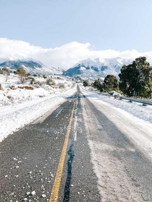 Asphalt Road with View of Snow Covered Mountains