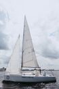 People on White Sail Boat Under Cloudy Sky
