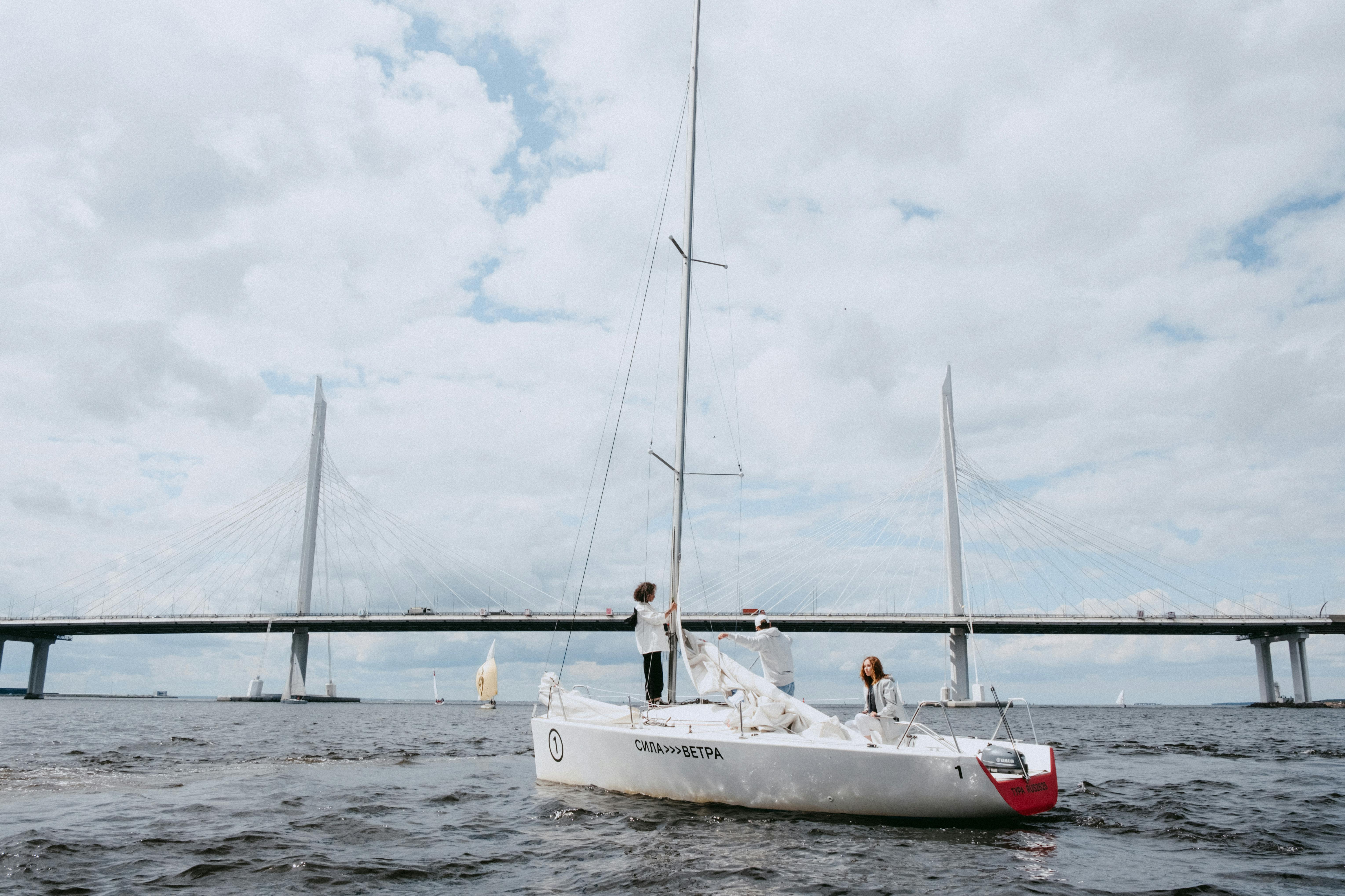 white sail boat on sea