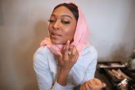 Woman in White Long Sleeve Shirt and Pink Hijab Applying Make-up