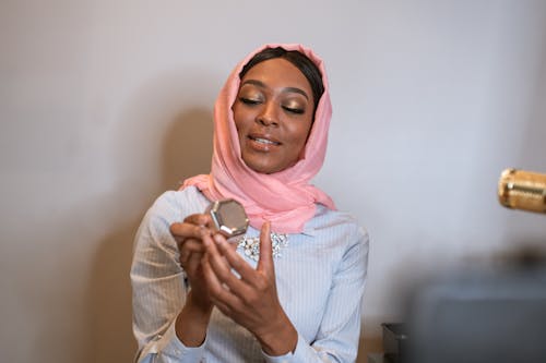 Woman in Pink Hijab doing her Makeup