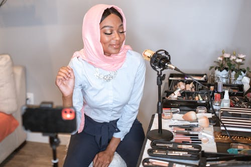 Female Vlogger in Pink Hijab doing a Makeup Video 