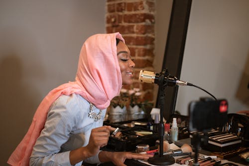 A Woman with Pink Hijab Testing Her Microphone