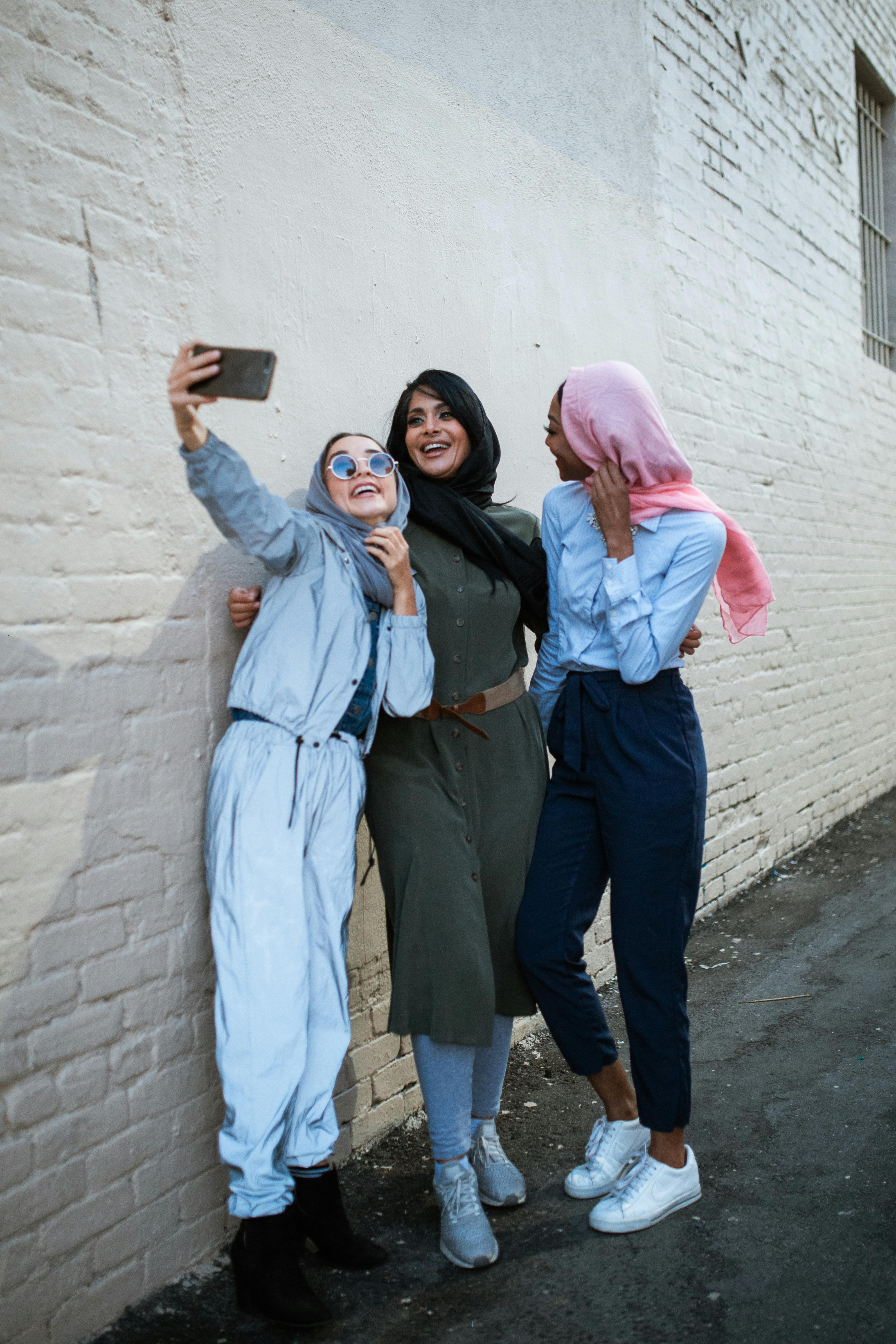 3 women standing taking a selfie