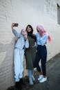 3 Women Standing Taking a Selfie