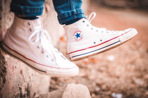 Free Close-up of white high-top sneakers worn outdoors, showcasing casual street style in Mumbai. Stock Photo