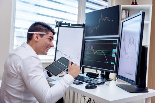 Happy Man looking at Screens 