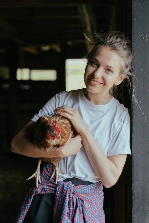 Girl in White Crew Neck T-shirt Holding Brown and White Fruit