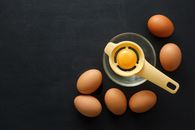 Eggs and glass bowl with egg separator