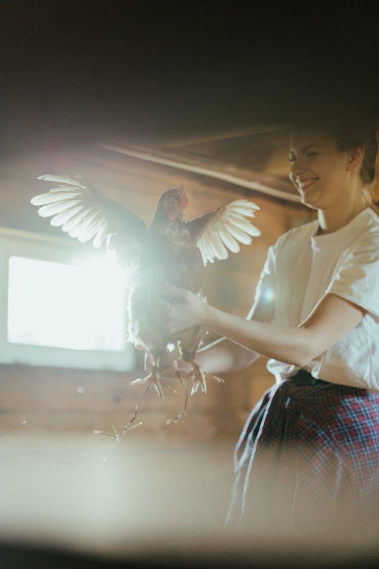 Happy Woman Holding A Hen 