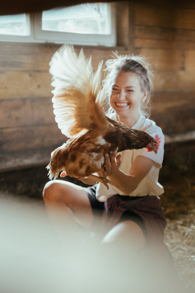 Happy Woman Holding A Hen 