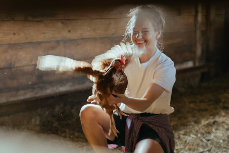 Happy Woman Holding A Hen 