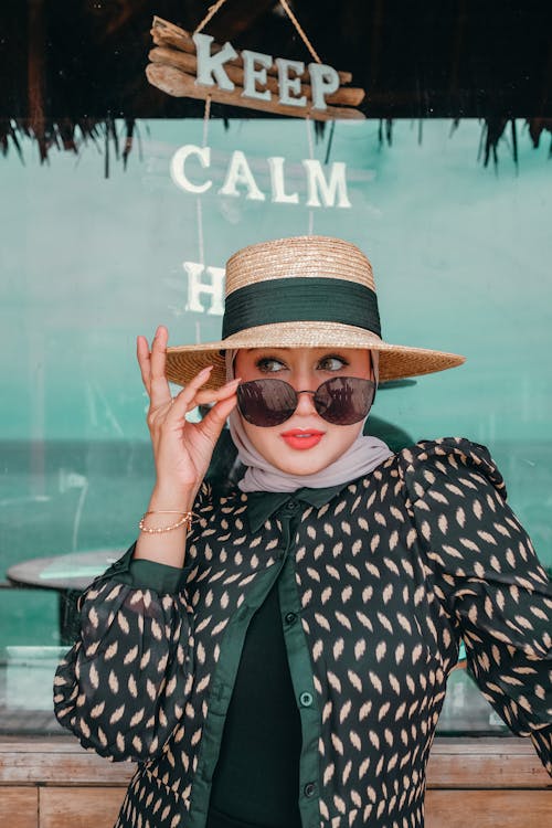 Beautiful Woman wearing Black Sunglasses and a Sunhat 