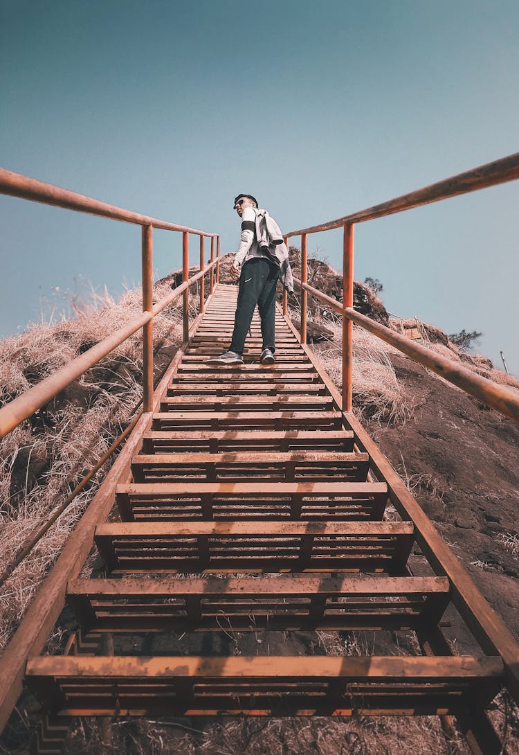 Man Walking On Metal Steps