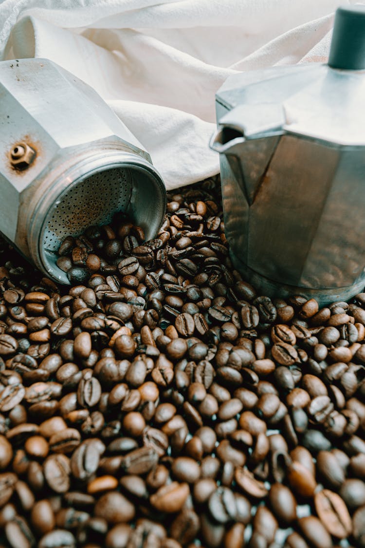 Metal Coffee Maker Near Pile Of Beans And Fabric Bag