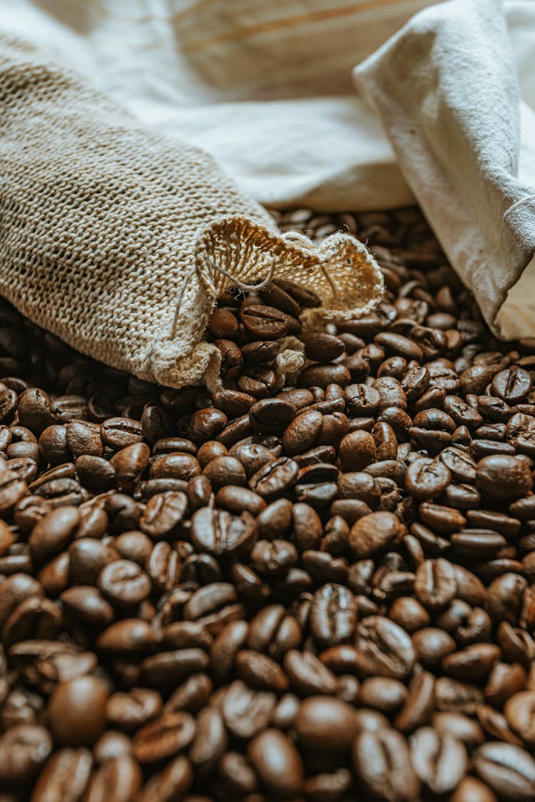 Zero Waste Bags On Heap Of Roasted Coffee Beans