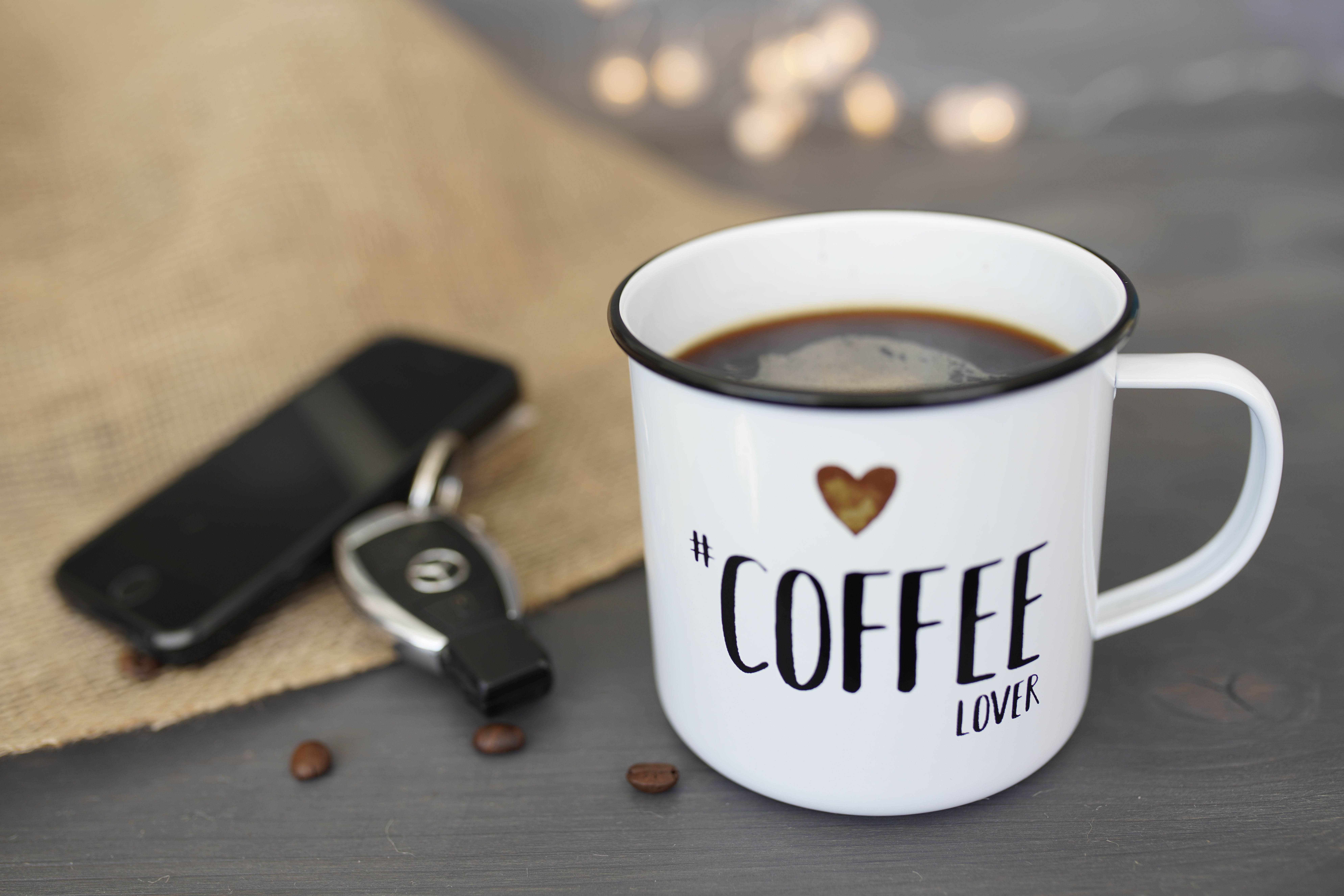 kitchen counter, bedroom dresser, or entry table at home coffee mug phone keys lifestyle photo 2