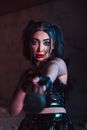 Woman with bright makeup in leather costume