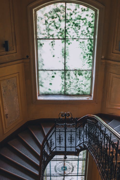 Staircase near window with muntin in old classic house