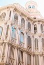 Facade of ornamental Moorish Revival building with tower against blue sky