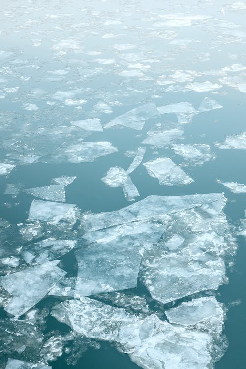 Large ice pieces floating in ocean water