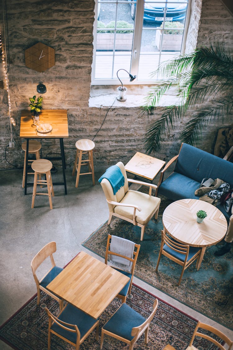 Cafe Interior With Furniture On Carpets Near Window