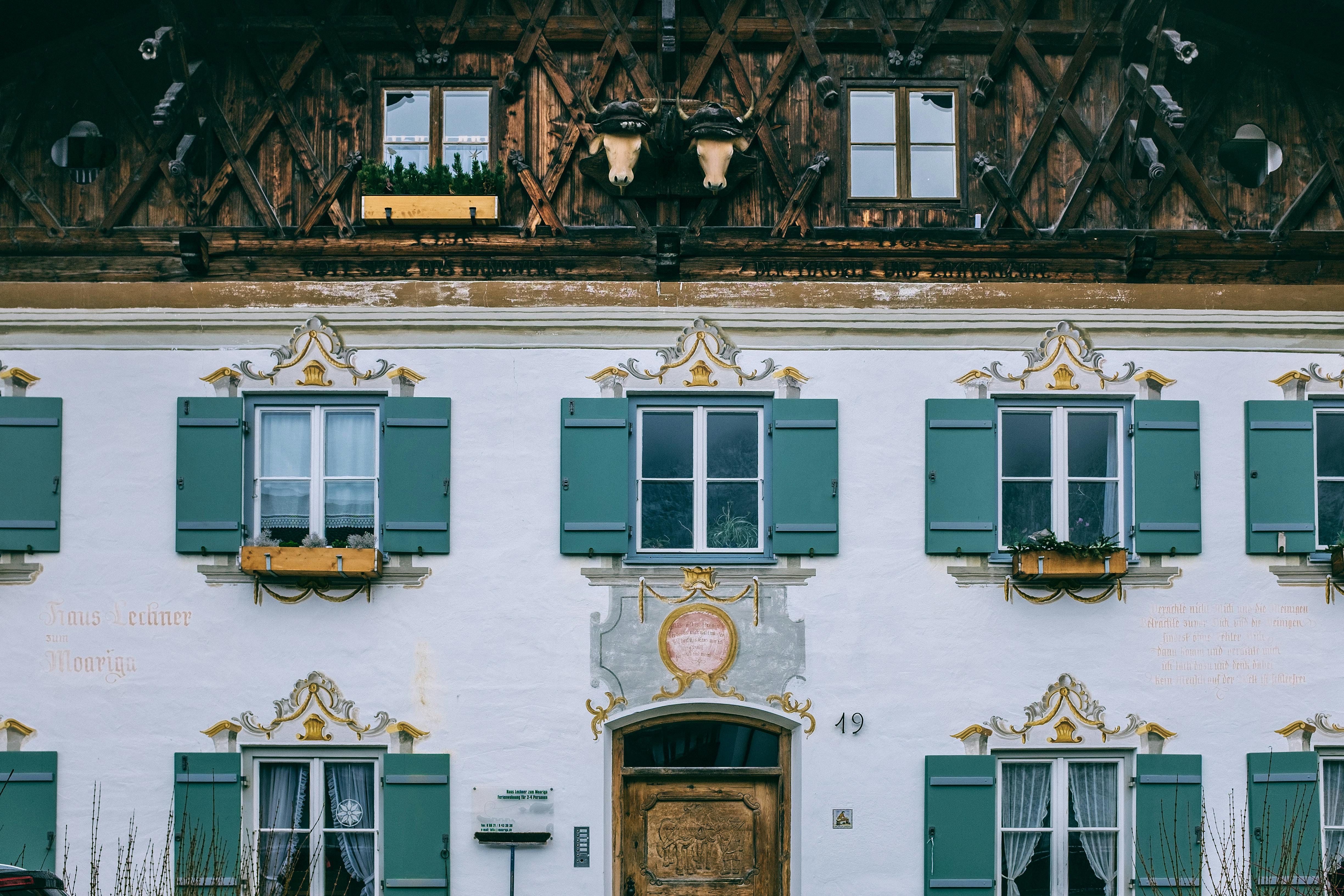 exterior of old house with ornamental wall in city