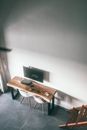 From above of living room with modern TV set above table with game console and remote controller