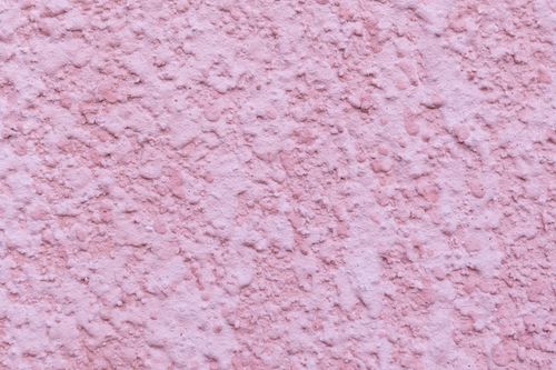 Free Minimalist background of pink colored wall covered with decorative fine plaster of building Stock Photo