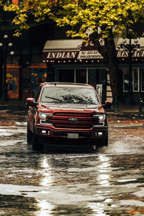 A Red Vehicle on a Flooded Road