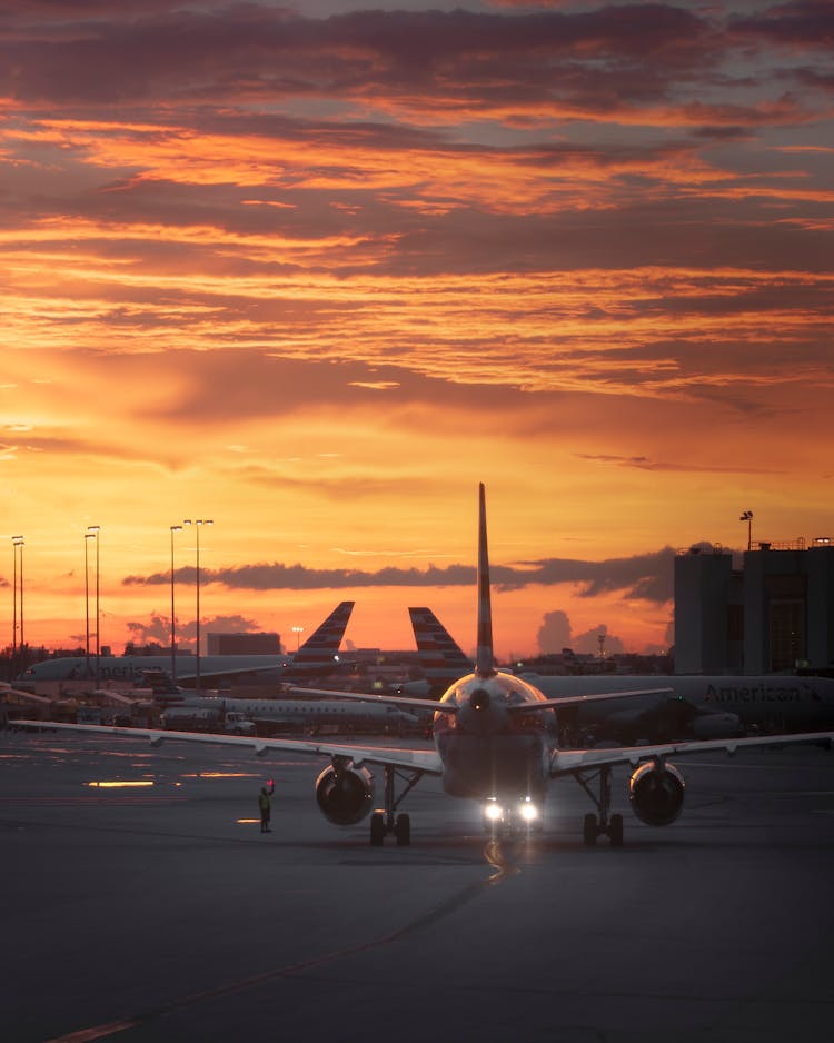 Airplanes On Tarmac During Sunset