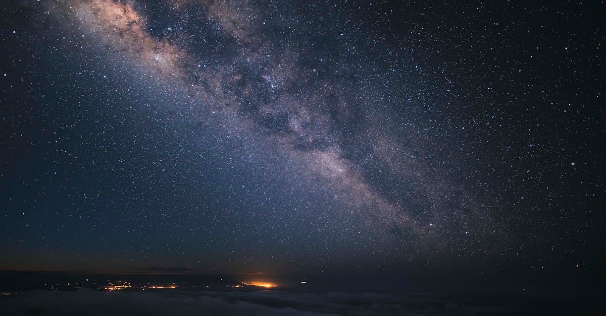 Photo by Alex Qian Stunning view of the Milky Way galaxy over Hawaii's night sky with a starry backdrop.