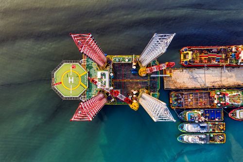 Free Drone shot of an offshore oil platform with helipad in Jakarta harbor. Stock Photo