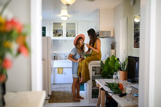 Joyful couple sharing a sweet moment in a bright, cozy kitchen.