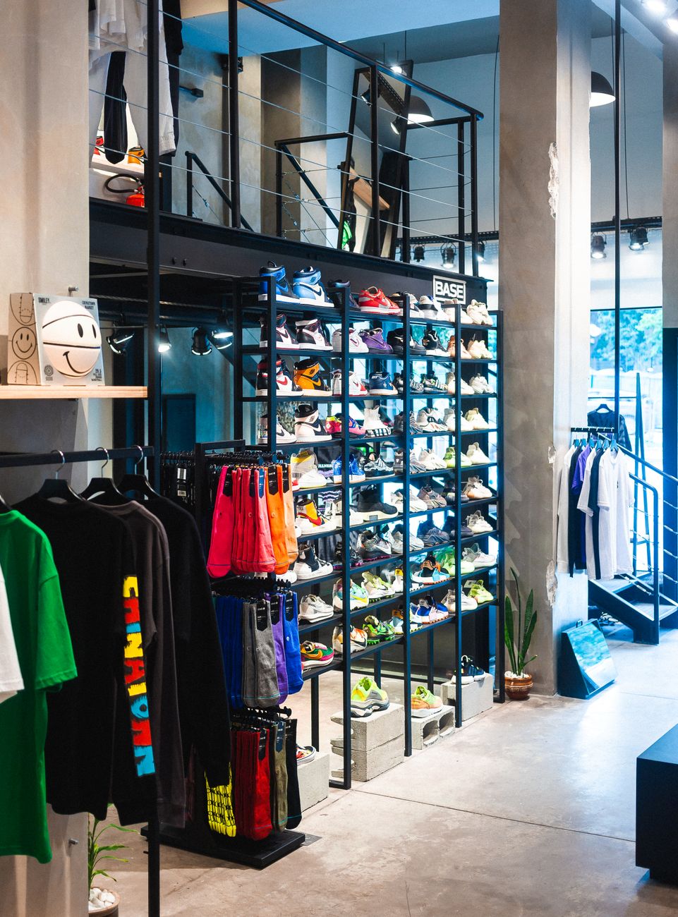 Interior of a modern store showcasing streetwear and footwear on shelves.