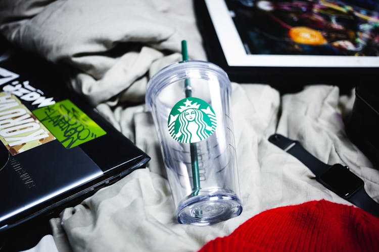 A Clear Starbucks Plastic Cup With Green Straw