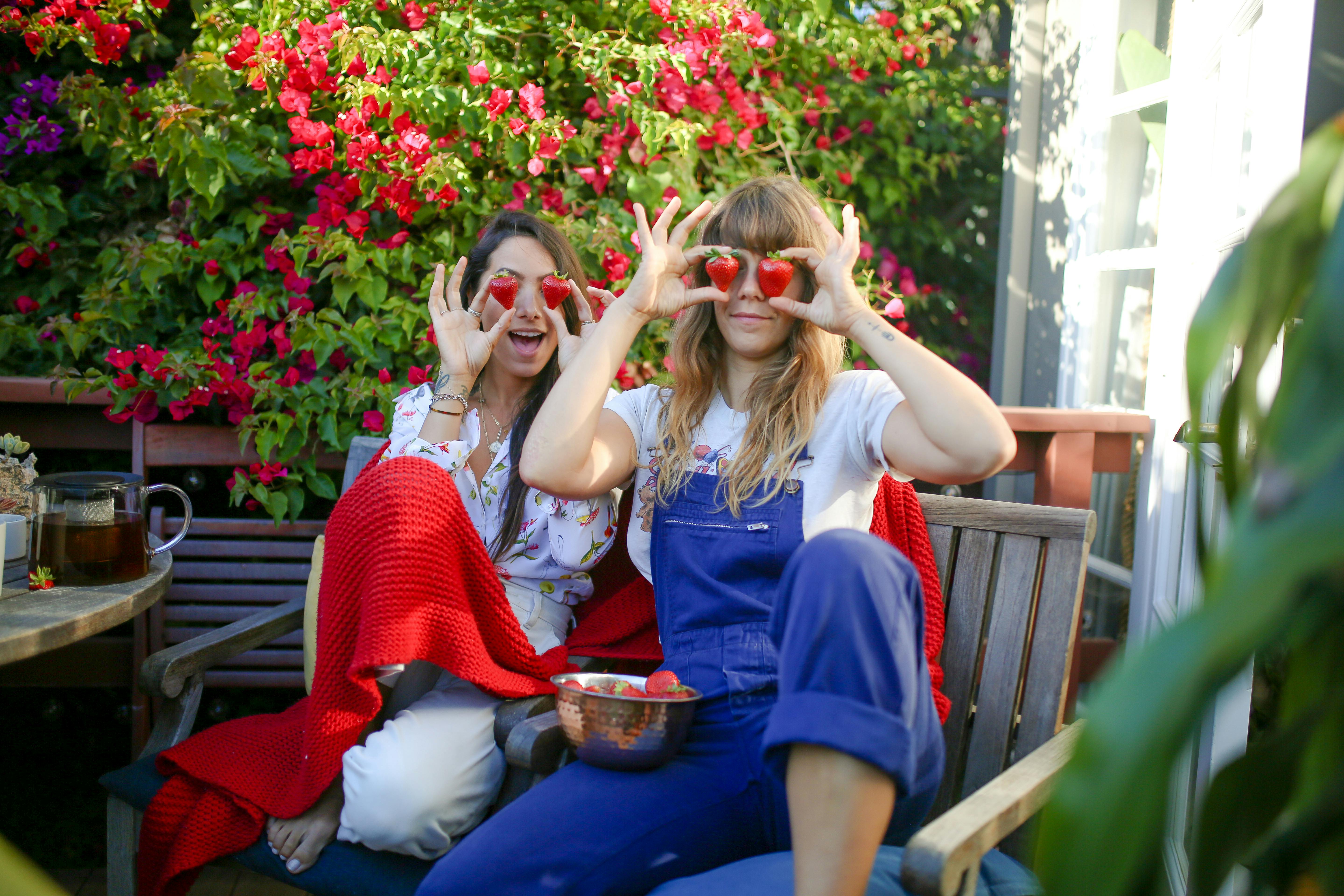 playful couple holding strawberries