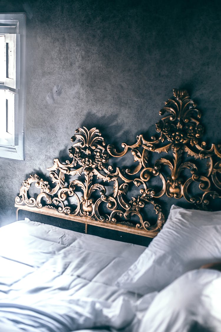 Bed With Cushion And Blanket With Ornamental Headboard