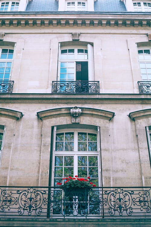 Old house facade with ornamental fence on balcony in city