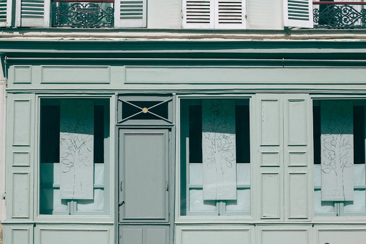 Old House Exterior With Shutters On Front Wall