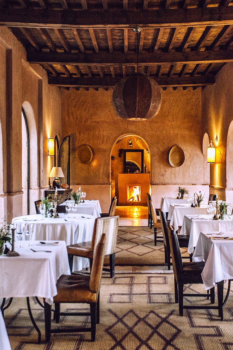 Banquet Tables In Restaurant With Shiny Fireplace