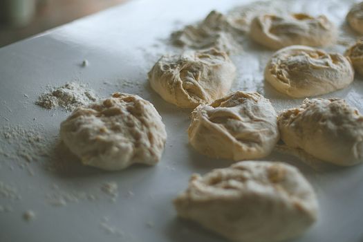 Raw dough on table with flour at home