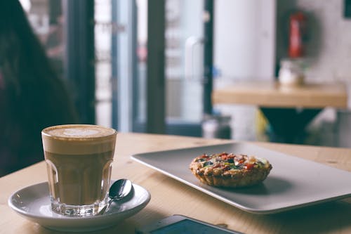 Free Glass of cappuccino near tasty frittata in cafe Stock Photo