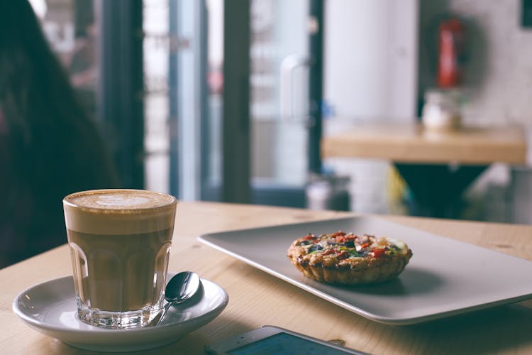 Glass Of Cappuccino Near Tasty Frittata In Cafe