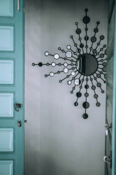 Decorative mirror on wall near door at home