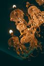 Chandelier with ornament and shiny lights in darkness