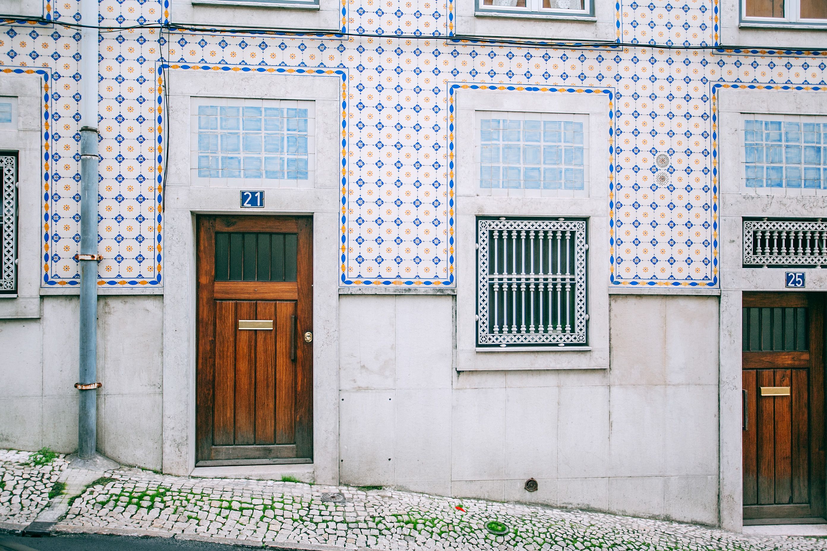 Facade of modern residential building with wooden doors and ornamental tiled walls in daylight